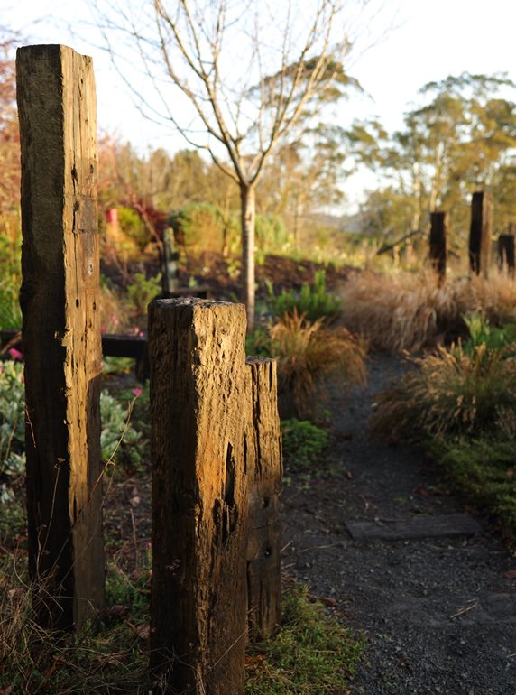 Railway ties in garden", classname:"img-fluid